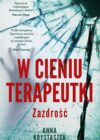 Okładka książki, rozbita szyba z kroplami wody, w połowie napis: W cieniu terapeutki, zazdrość, Anna Krystaszek